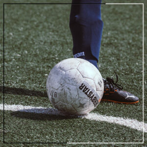 Ein Fuß steht neben einem Fußball.